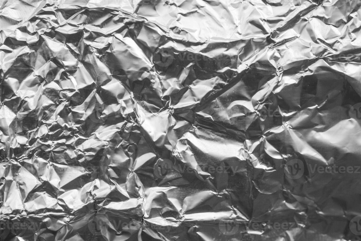 Shiny metal silver gray foil crumpled texture background photo