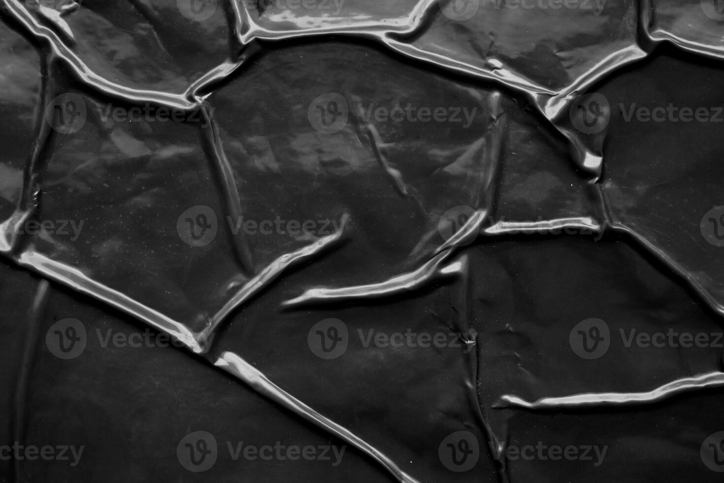 black crumpled and creased plastic poster texture background photo