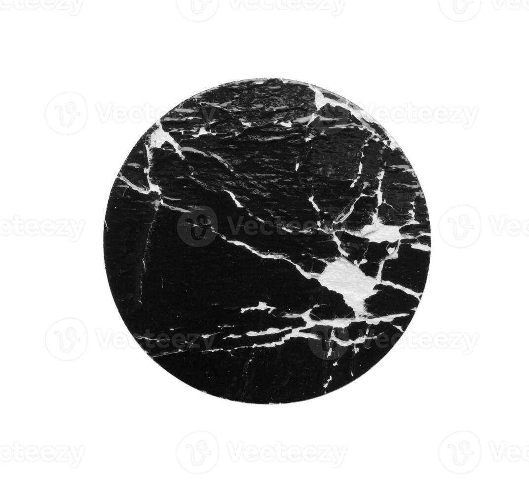 Black old scratched round paper sticker isolated on white background photo