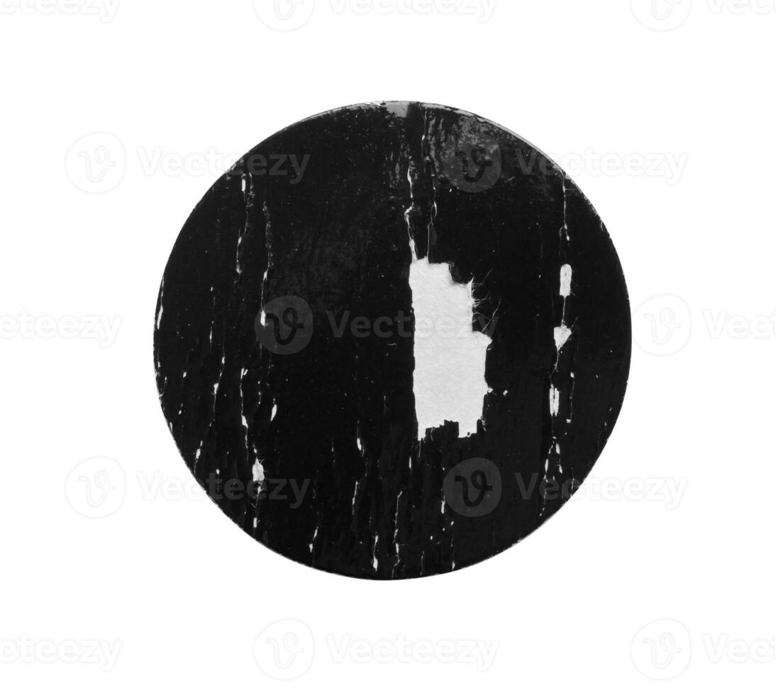 Black old scratched round paper sticker isolated on white background photo