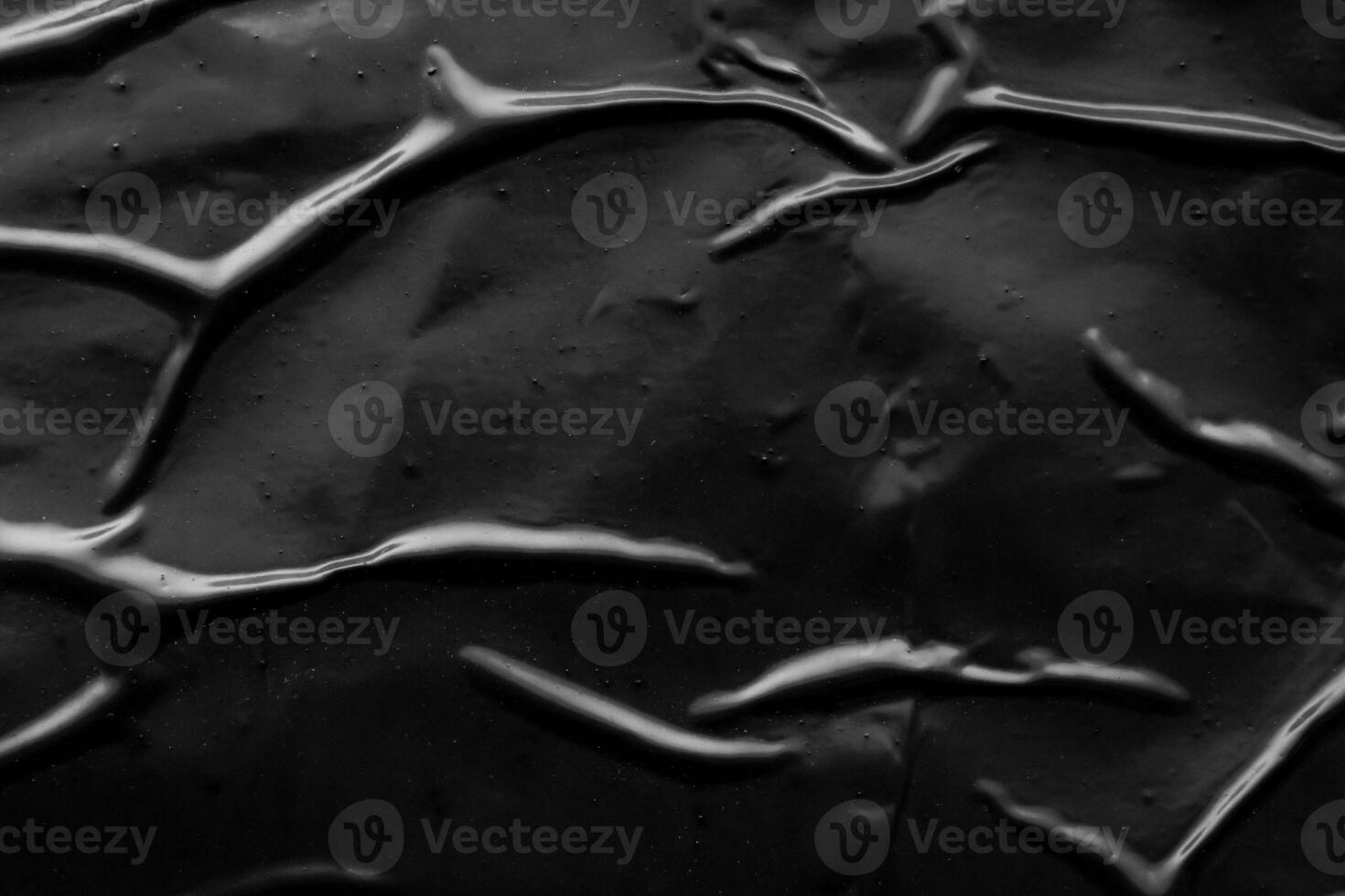 black crumpled and creased plastic poster texture background photo