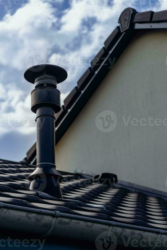 Chimney of a wood or pellet stove installed on the roof photo