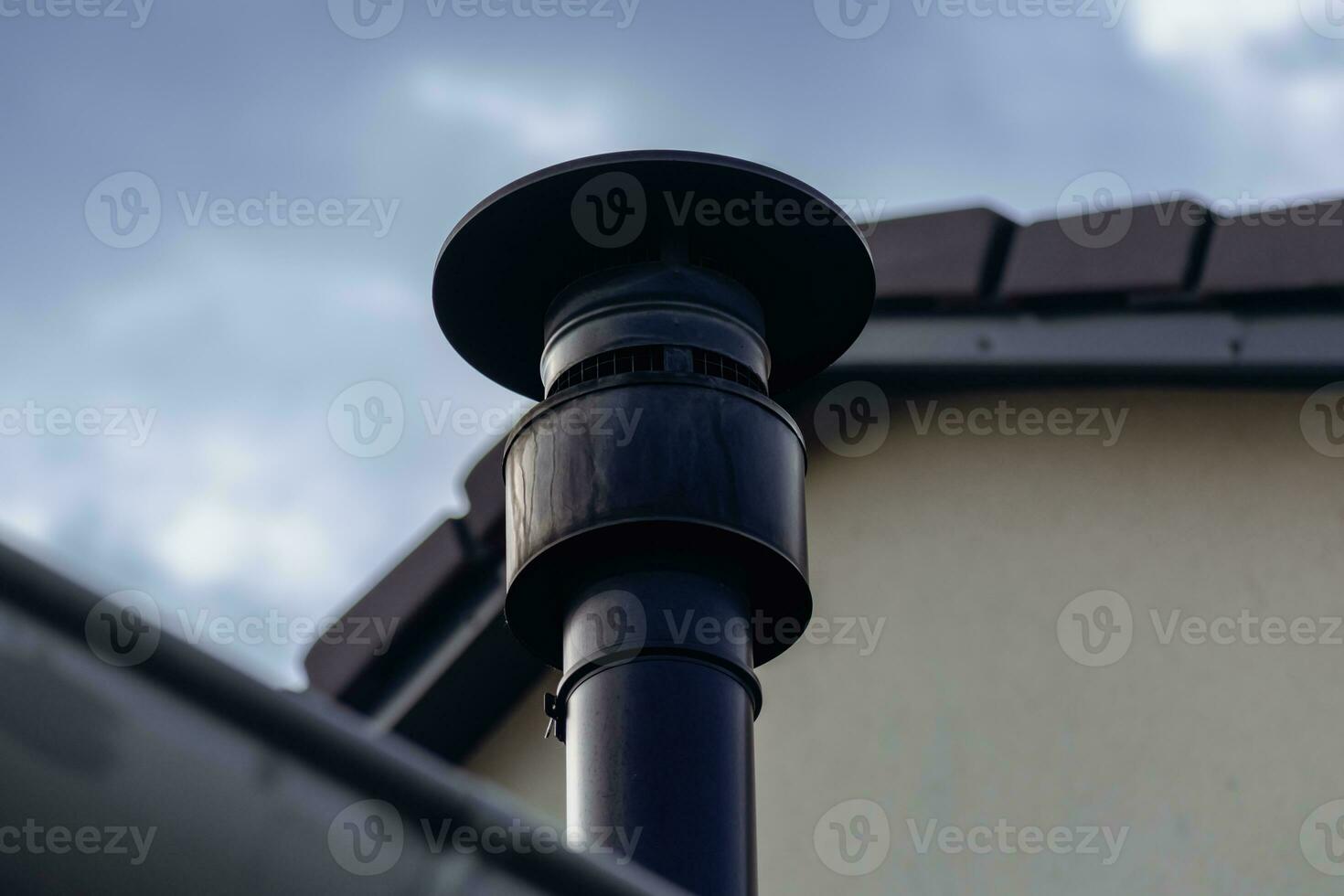 Chimney of a wood or pellet stove installed on the roof photo