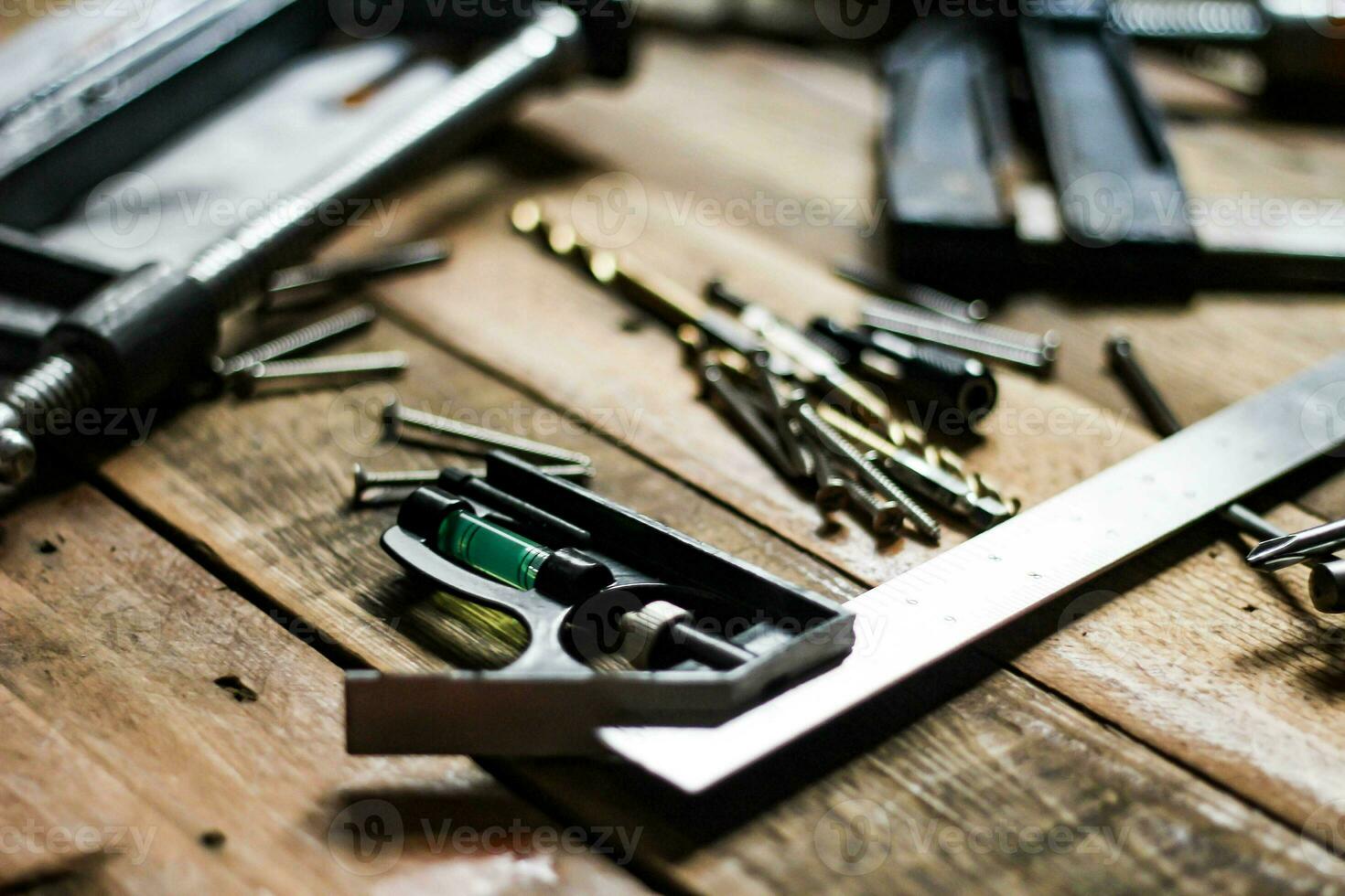 A set of woodworking tools in contrasting tones on the wood floor. photo