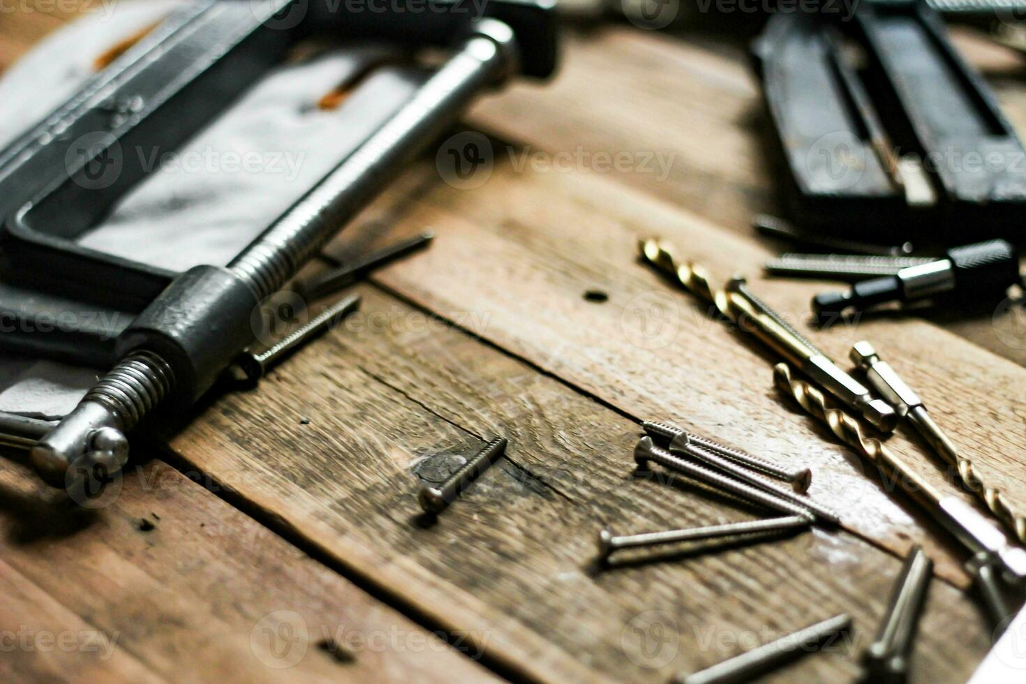 A set of woodworking tools in contrasting tones on the wood floor. photo