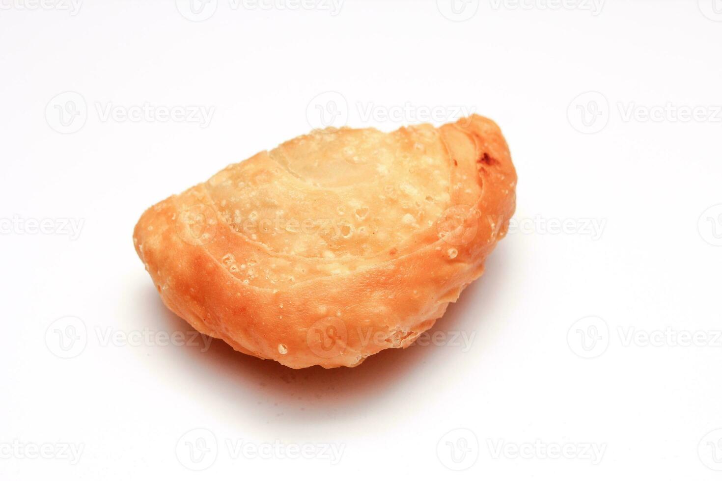 Fried flour snack or curry puff filled with chicken, a popular snack in Thailand. placed on a white background photo