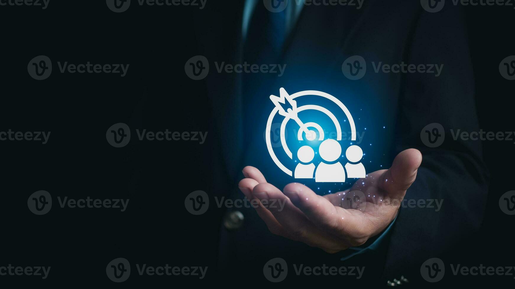 Human hand holding customer icons on dark background. Represents the selection of business goals, target customers, marketing plans and strategies, and customer-centric strategies. photo