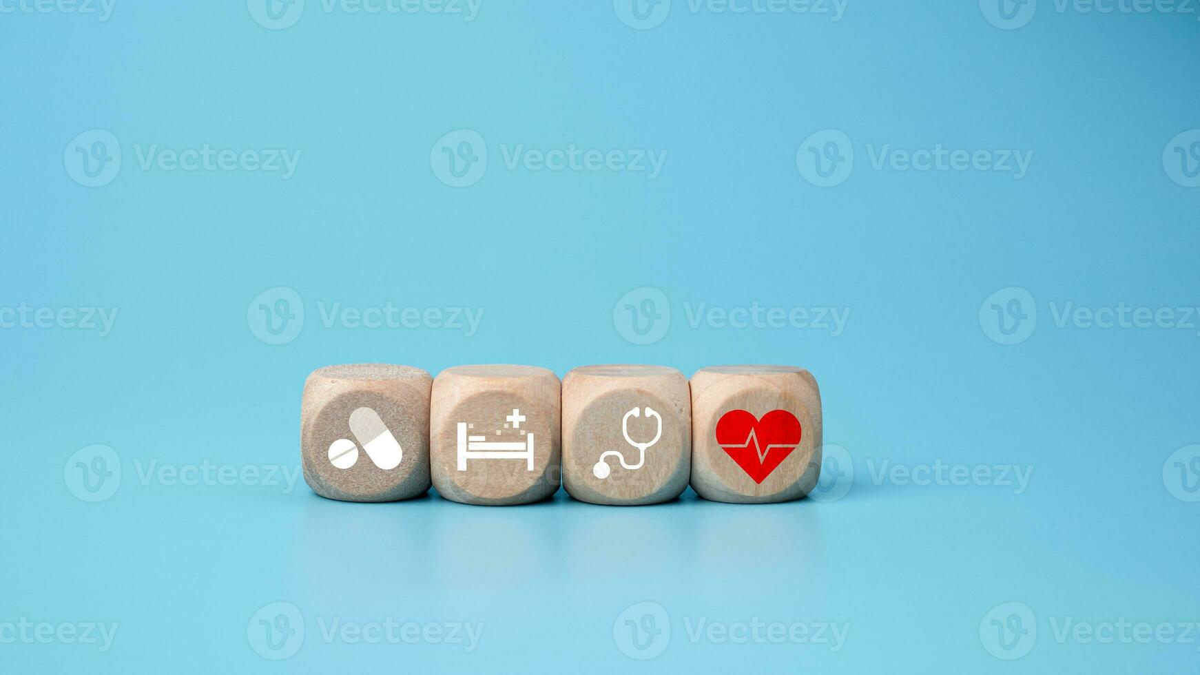Wooden blocks with medical symbol icons on blue background representing health concept with treatment and medicine. photo
