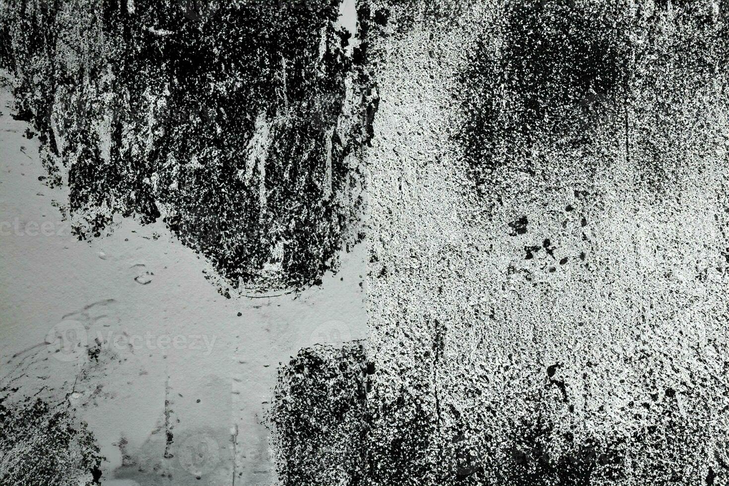 Abstract grunge texture pattern of black paint on white wall photo