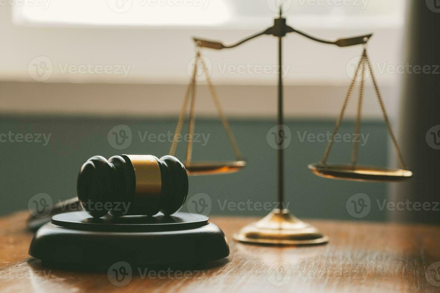 Business and lawyers discussing contract papers with brass scale on desk in office. Law, legal services, advice, justice and law concept picture with film grain effect photo