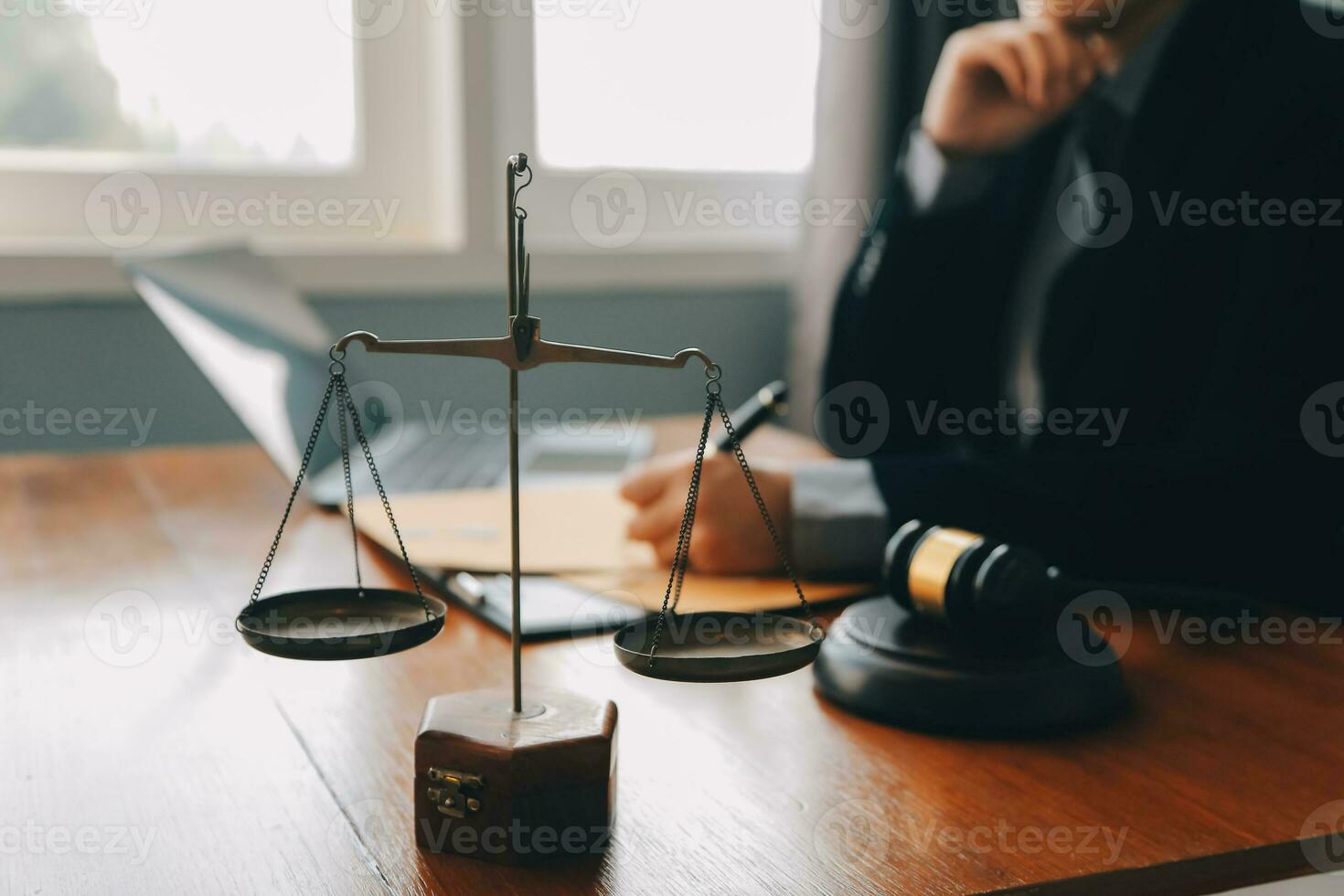 Business and lawyers discussing contract papers with brass scale on desk in office. Law, legal services, advice, justice and law concept picture with film grain effect photo