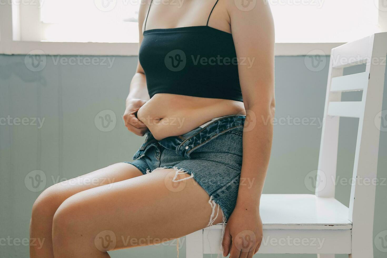 fat woman, fat belly, chubby, obese woman hand holding excessive belly fat with measure tape, woman diet lifestyle concept photo