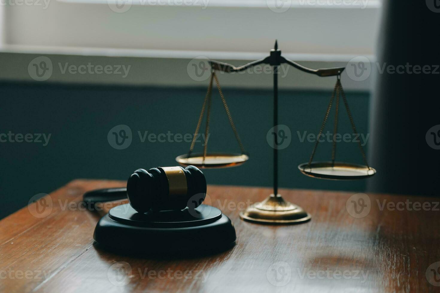 Business and lawyers discussing contract papers with brass scale on desk in office. Law, legal services, advice, justice and law concept picture with film grain effect photo