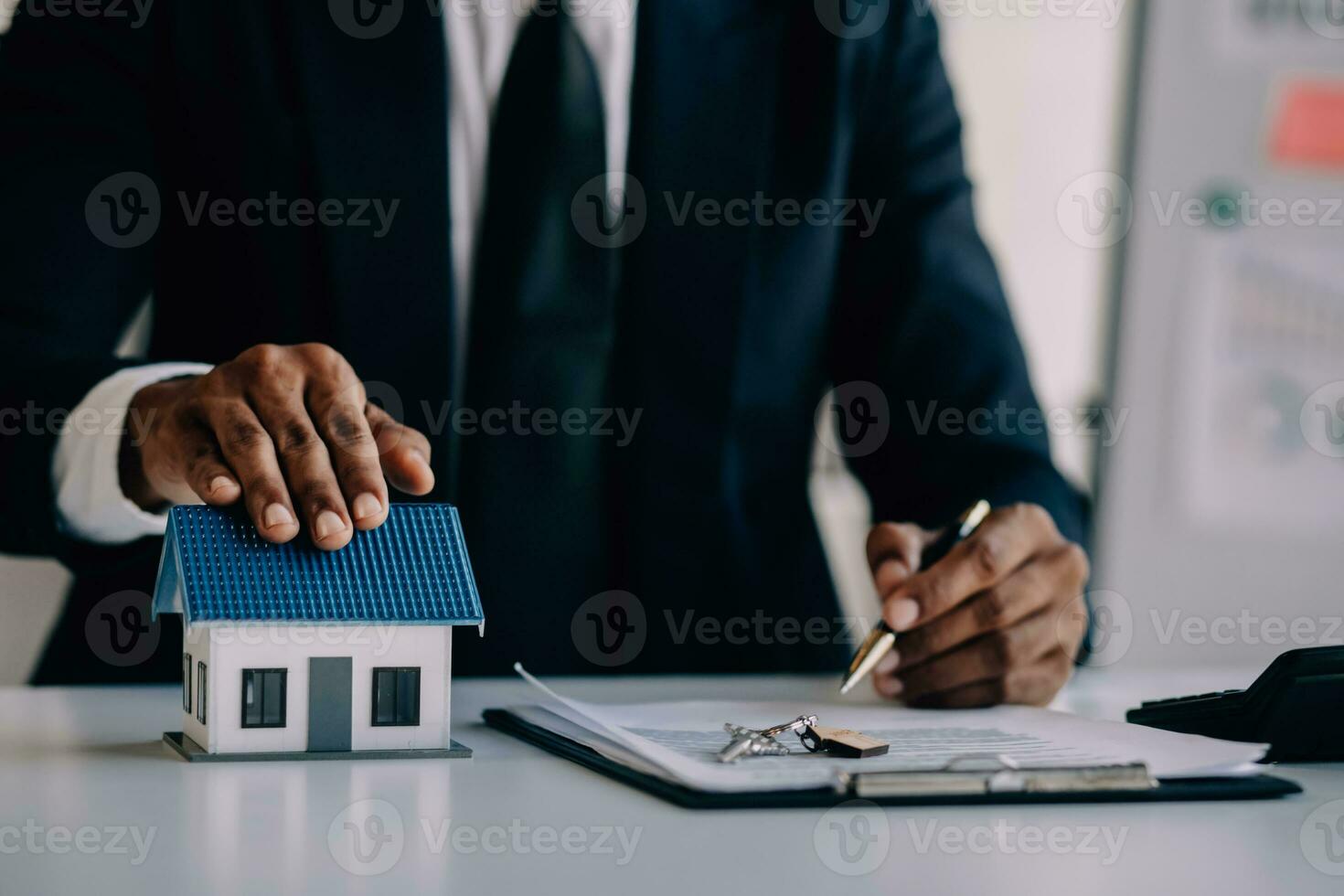A couple is approaching a housing project to buy, and they are discussing details and advice with a salesperson in a housing project. Real estate trading ideas with couples. photo