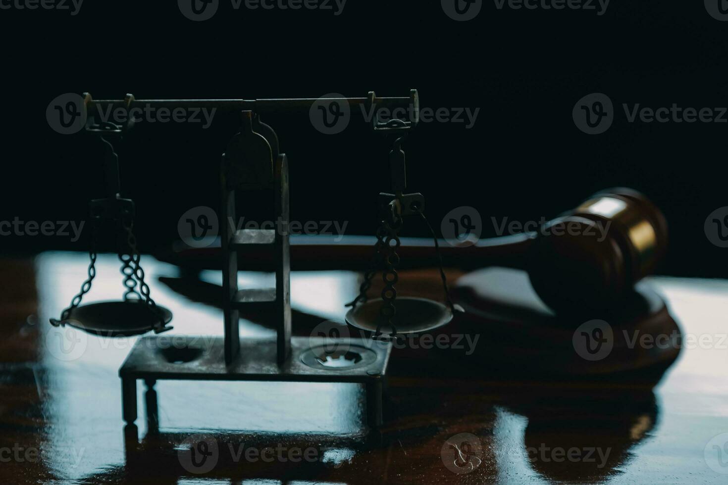 Justice and law concept.Male judge in a courtroom with the gavel, working with, computer and docking keyboard, eyeglasses, on table in morning light photo