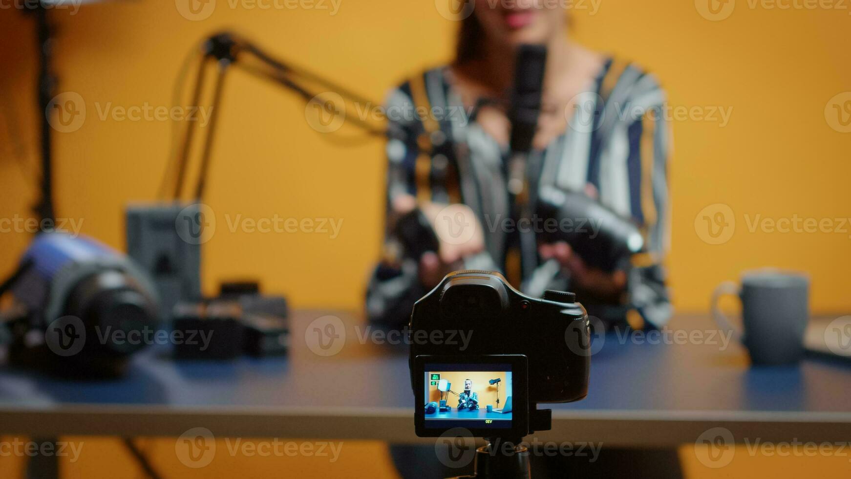 Selective focus on expert talking about camera lens. Content creator new media star influencer on social media talking video photo equipment for online internet web show