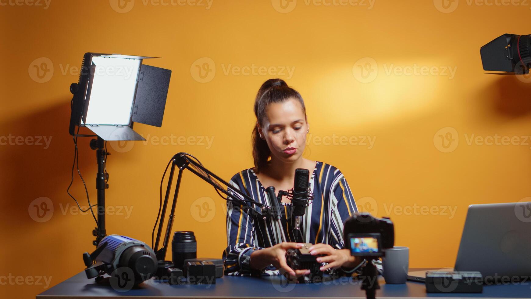 New media start presenting a fluid head plate to the camera. Influencer making online internet content about video equipment for web subscribers and distribution, digital vlog talking film photo