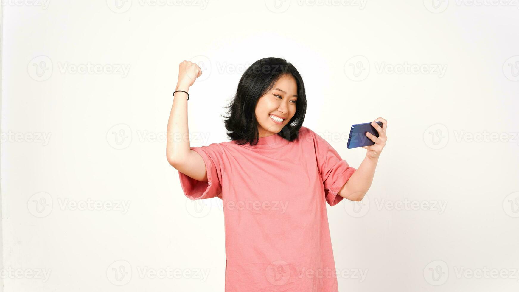 Happy asian woman playing game using mobile phone isolated on a white background. photo