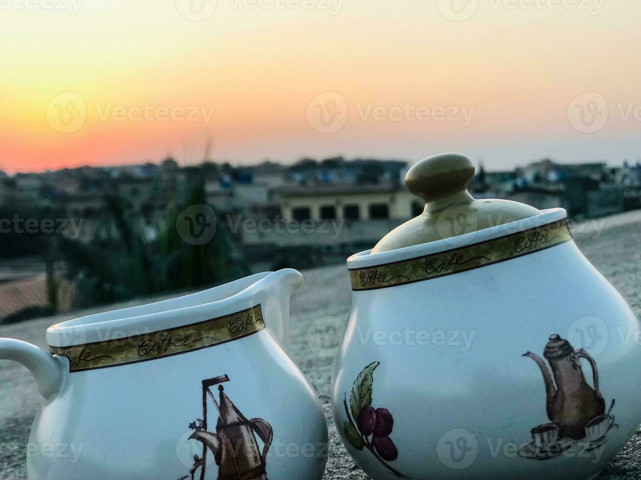 two white and brown jugs with designs on them photo