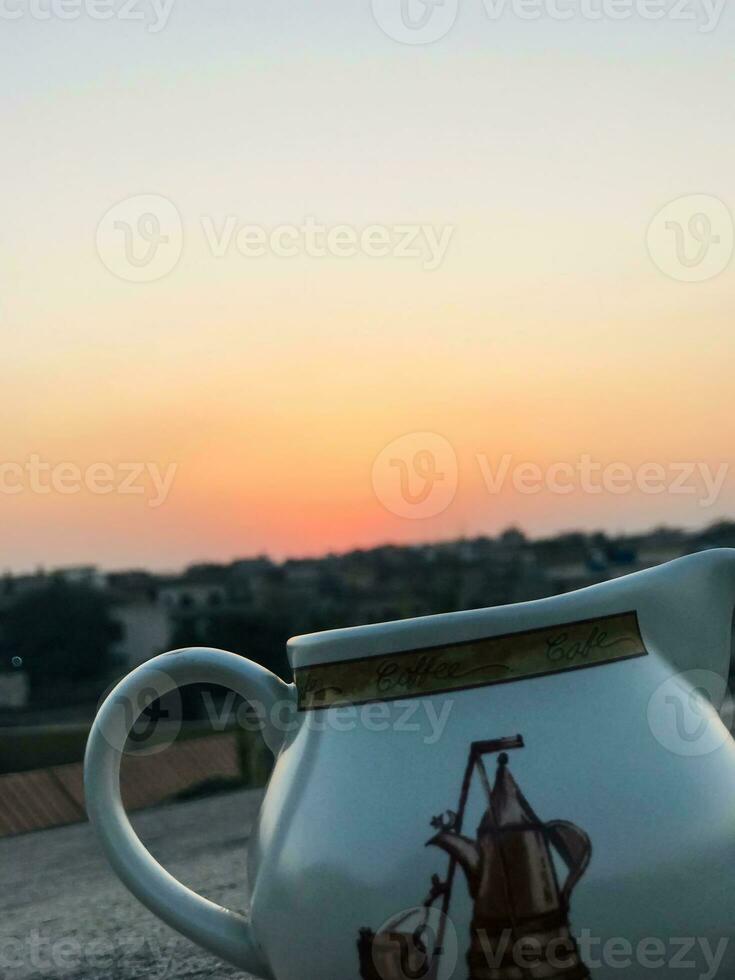 two white and brown jugs with designs on them photo