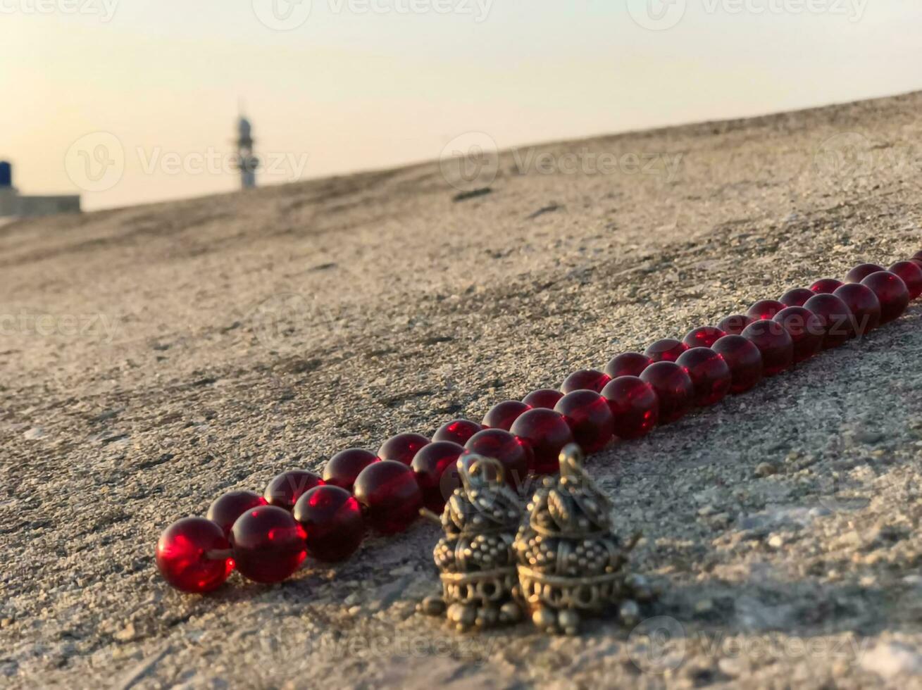 a red bead on the ground next to a tower photo