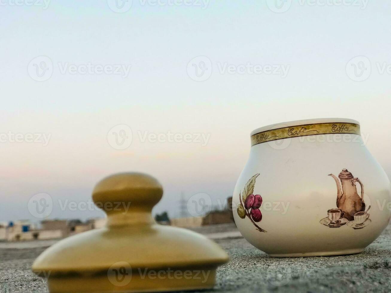 two white and brown jugs with designs on them photo