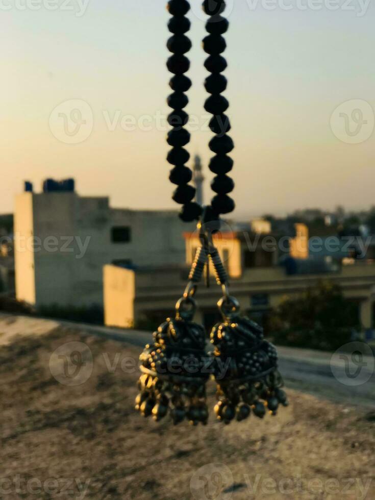 a necklace with two black beads hanging from a rope photo