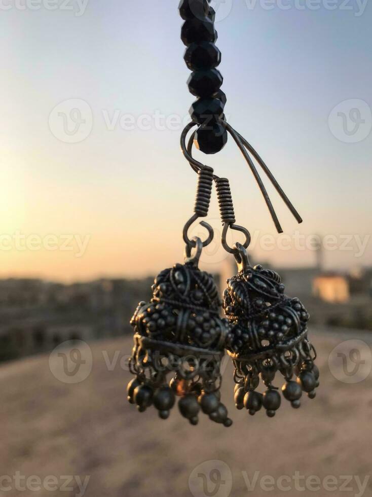 a pair of earrings hanging from a rope photo