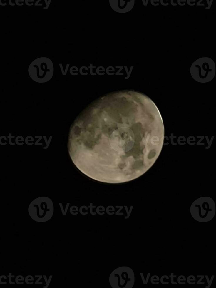 the moon is seen in the dark sky photo