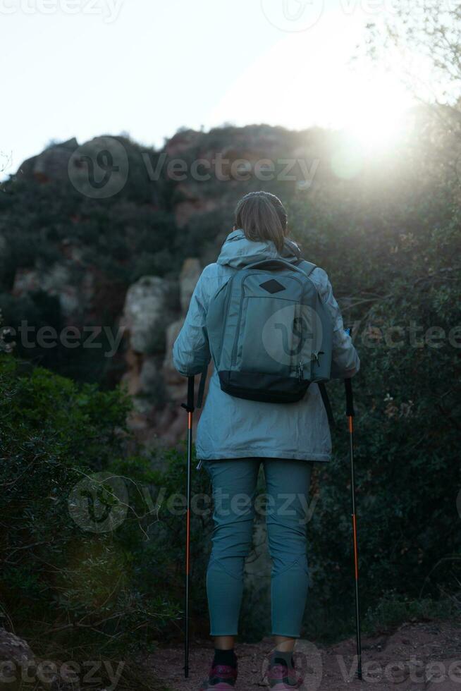 Woman contemplates the landscapes of the Garraf Natural Park while walking the paths of a mountain. photo