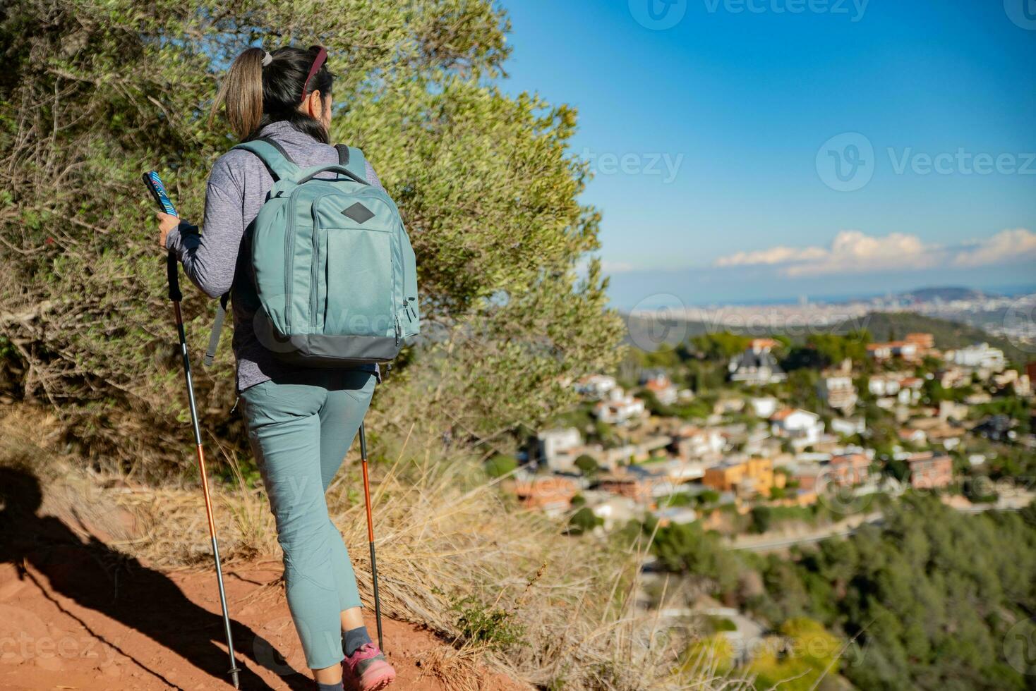 Woman contemplates the landscapes of the Garraf Natural Park while walking the paths of a mountain. photo