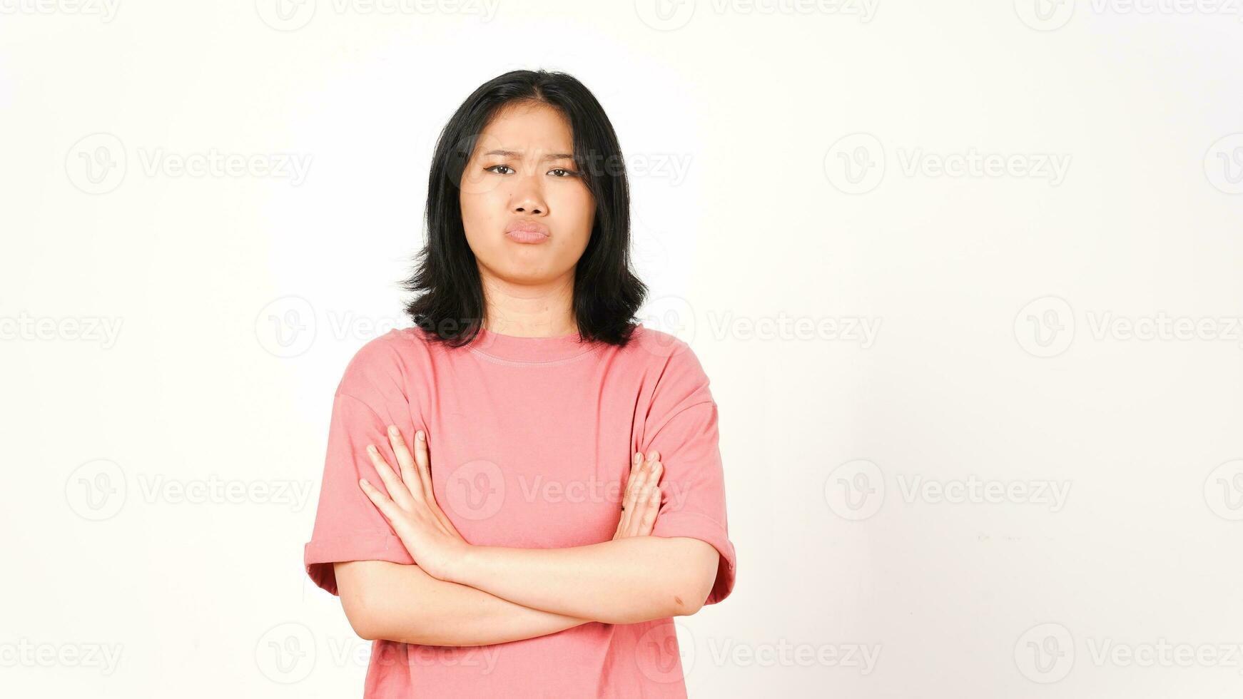 Young Asian woman in pink t-shirt with arms crossed and angry face on isolated white background photo