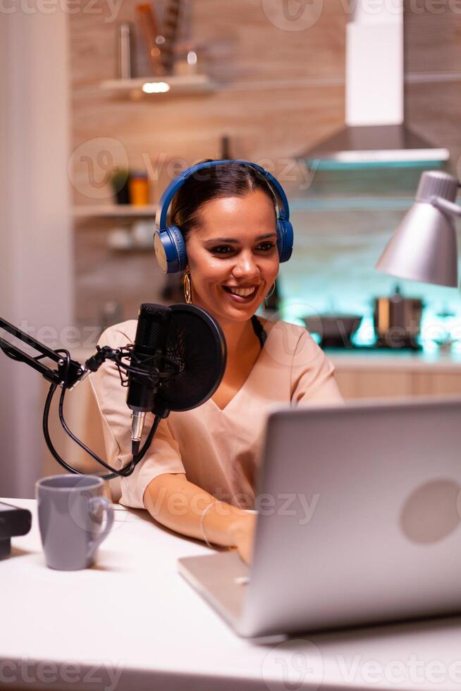 Host of night show speaking and taking notes on clipboard. Creative online show On-air production internet broadcast host streaming live content, recording digital social media communication photo