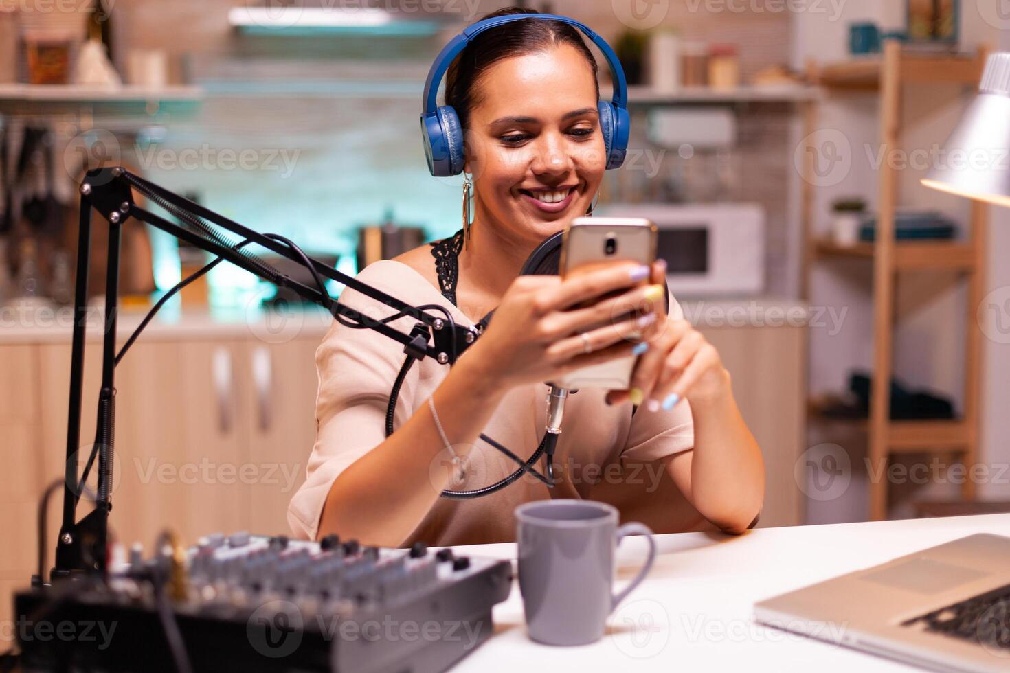 New media star using smartphone in home studio and recording vlog. Creative online show On-air production internet broadcast host streaming live content, recording digital social media communication photo