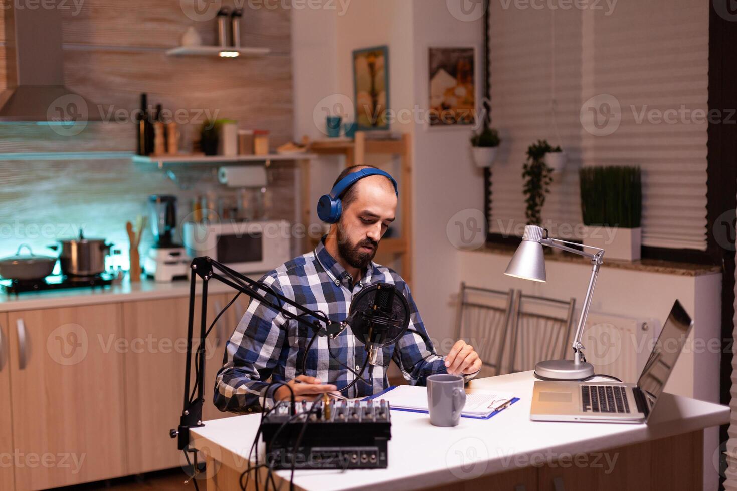 Business man recording talk show at home studio with laptop on table. reative online show On-air production internet broadcast host streaming live content, recording digital social media communication photo