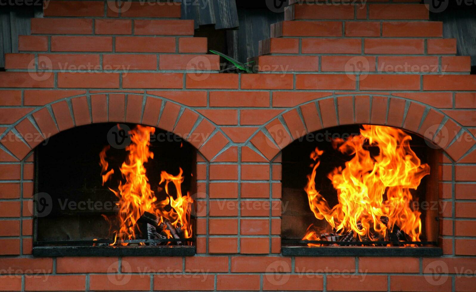 Wood Logs Burning In A Double Brick Oven photo