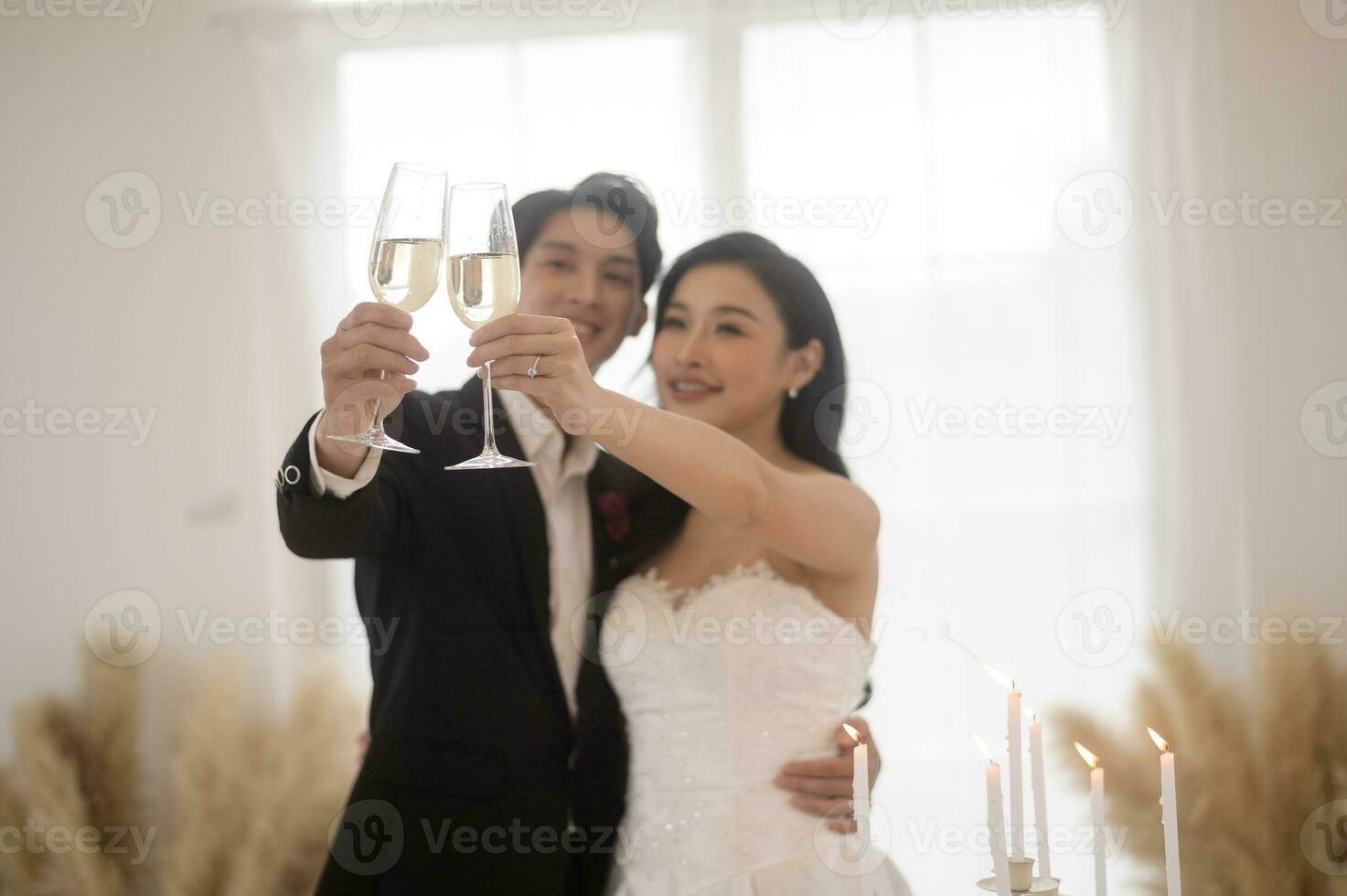 Bride and groom holding glasses of champagne at the wedding ceremony photo