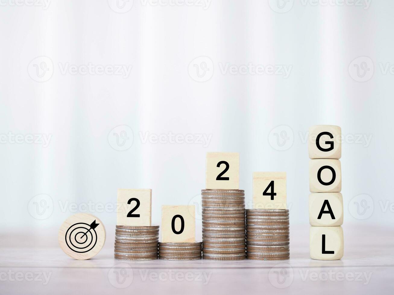 Wooden block with word GOAL and number 2024 on stack of coins. The concept of saving money for Business achievement goal, Financial, Investment and Business growing in new year 2024. photo