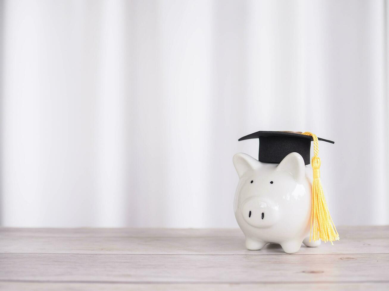 Piggy bank with graduation hat. The concept of saving money for education, student loan, scholarship, tuition fees in future photo