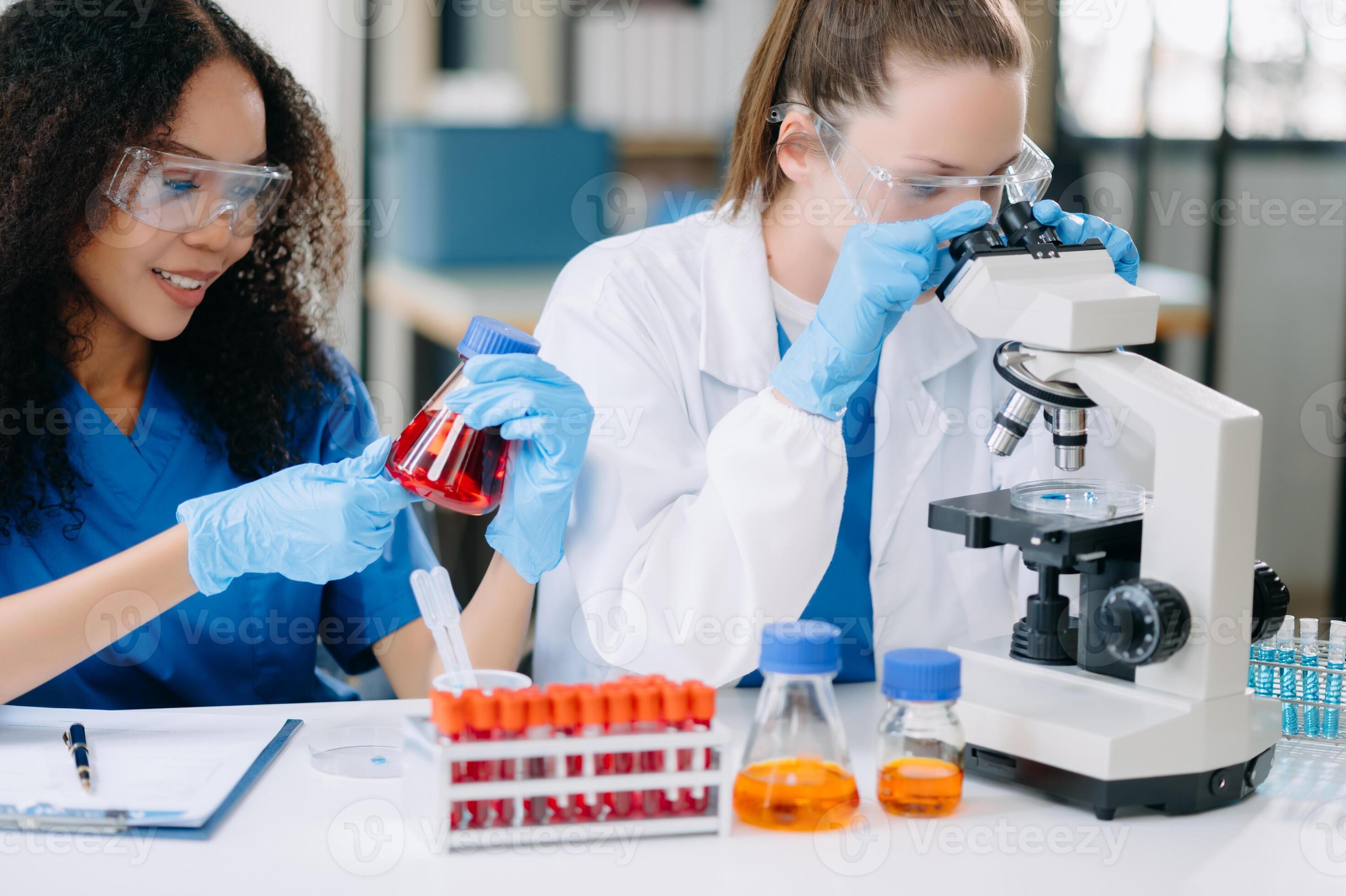 Scientist team meeting and writing analysis results in the laboratory ...