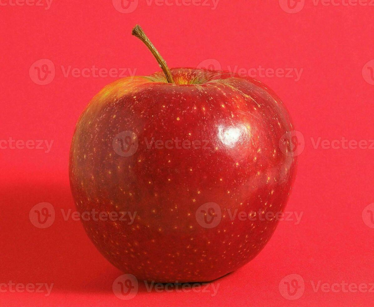 an apple is shown on a red background photo