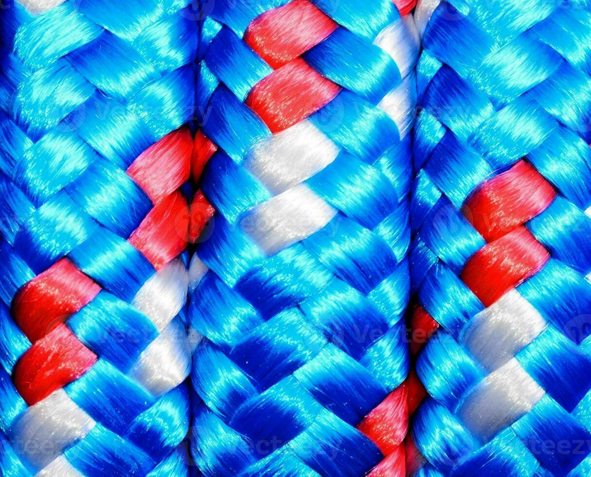 a close up of blue, red and white braided ropes photo