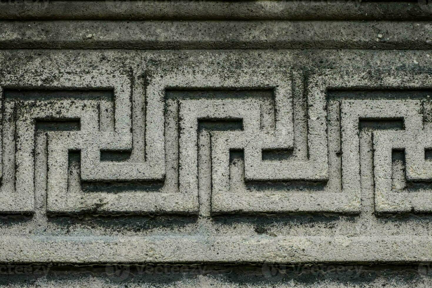 a close up of a stone wall with a greek design photo