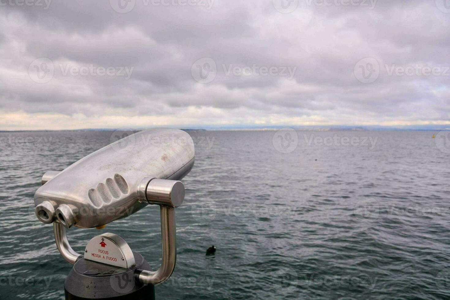 a silver binocular overlooking the ocean photo