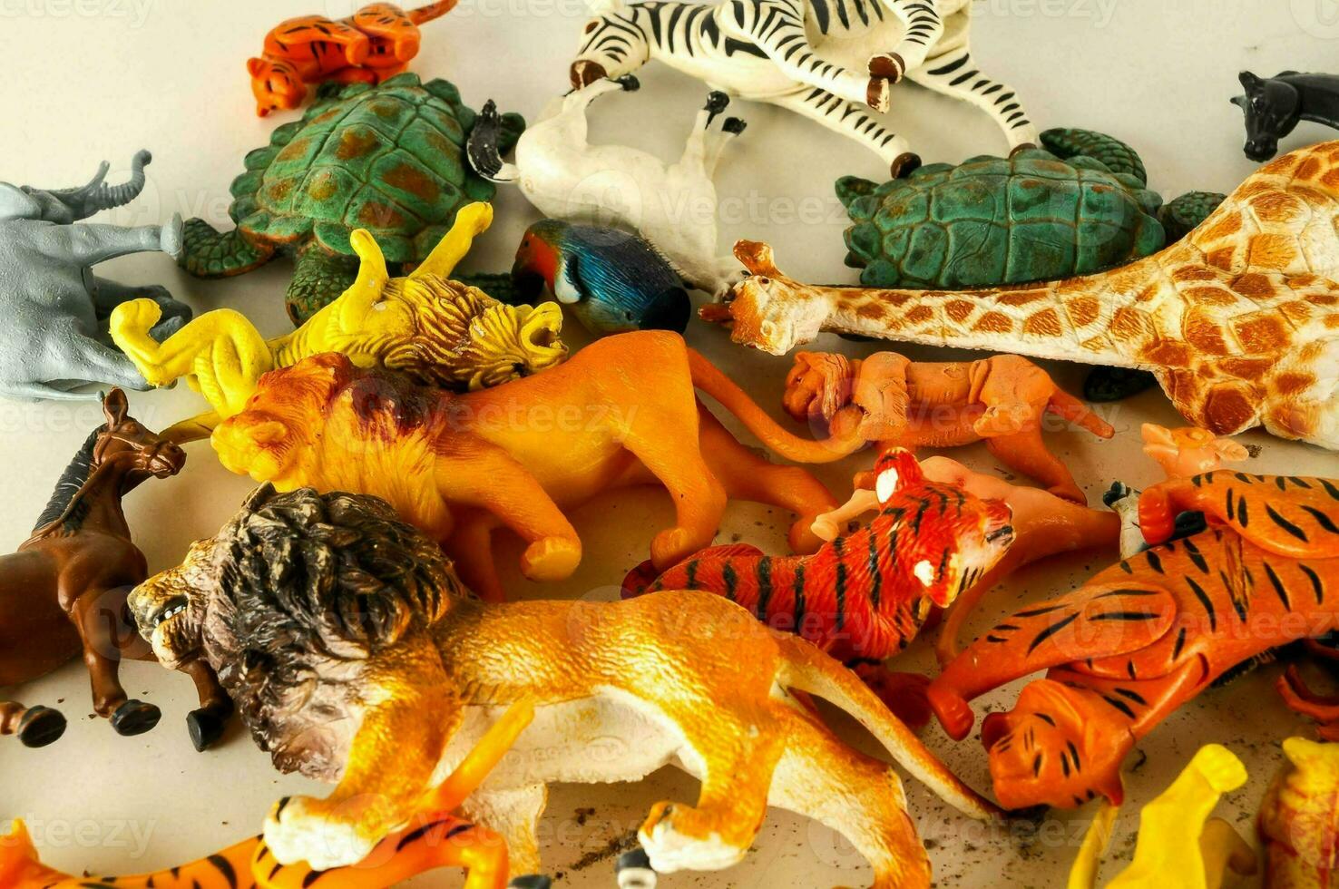 a pile of plastic animals that are scattered on a table photo