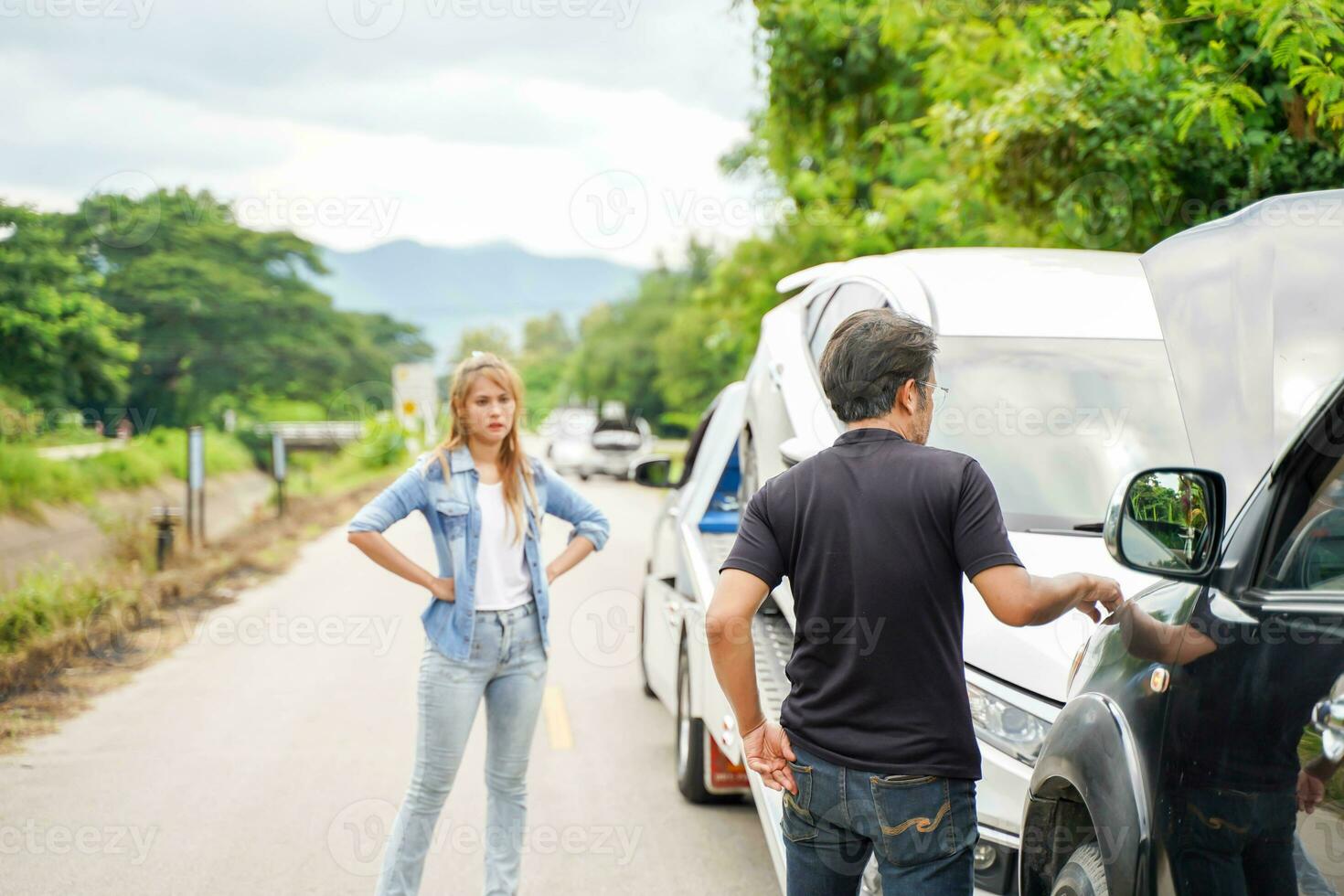 Drivers stood arguing after the car crashed on country road. photo