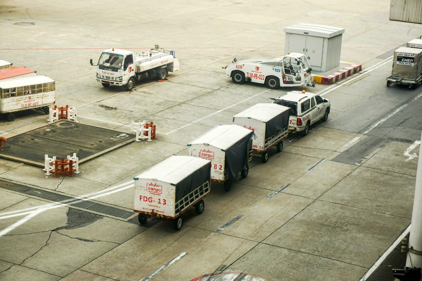 Bangkok City, Thailand, 2018 - Cargo service and airport baggage loader cart in Don Mueang International Airport. photo