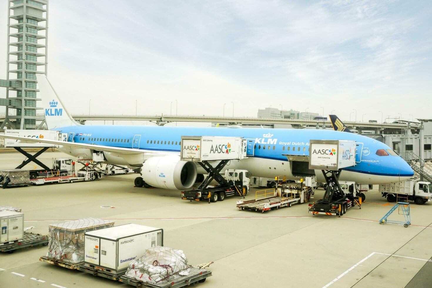 Osaka City, Japan, 2018 - Blue airplane of KLM Royal Dutch Airline arriving at Kansai International Airport, Japan with loading baggage and travelers from the plane to the terminal. photo