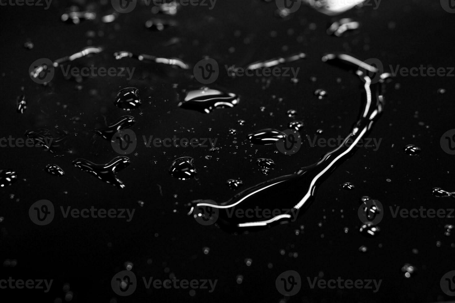 Water spread in heart shape with reflection lightning on black background. photo