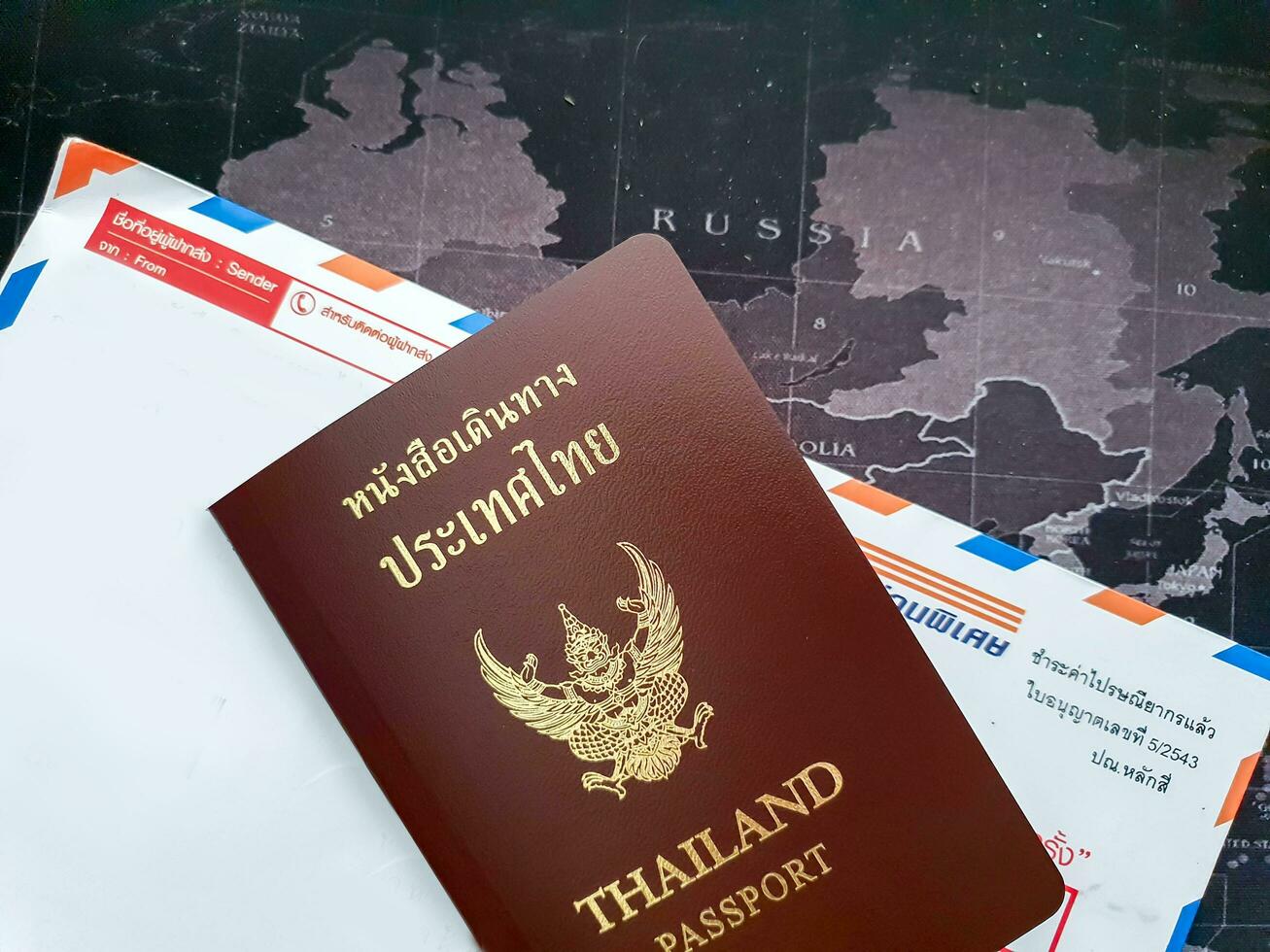 Bangkok City, Thailand, 2018 -Thai passport book on envelope and world map background. photo